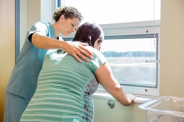 Midwife with woman in labour