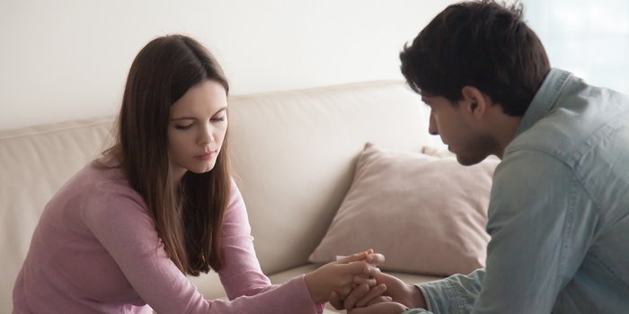 Sad couple comfort each other